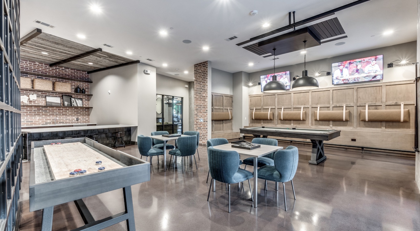 a game room with a pool table, bar and television at The Cedar at Branch