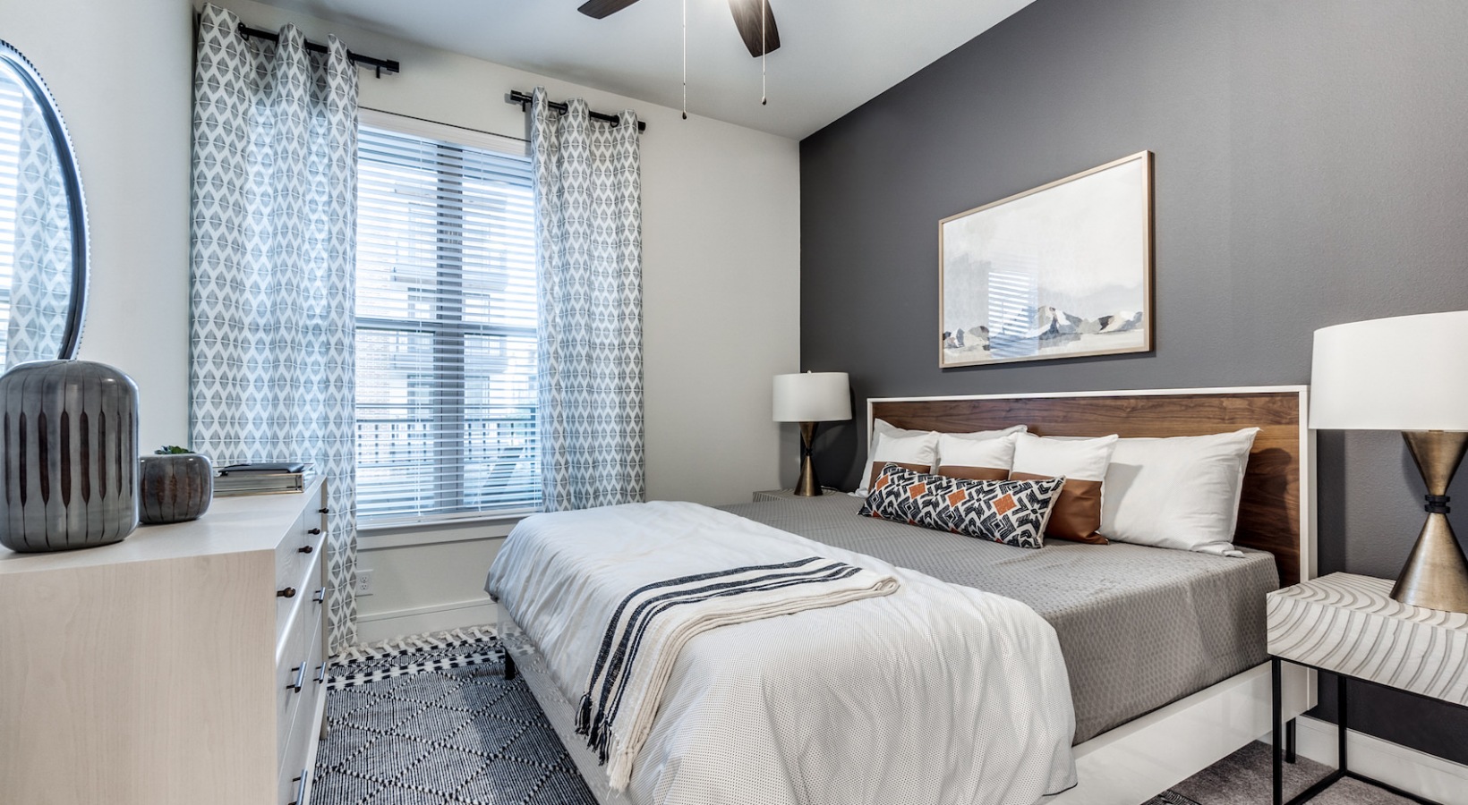 a bedroom with a bed, dresser and nightstand at The Cedar at  Branch