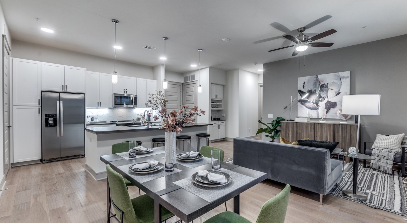 a modern kitchen and dining area with a ceiling fan at The Cedar at  Branch