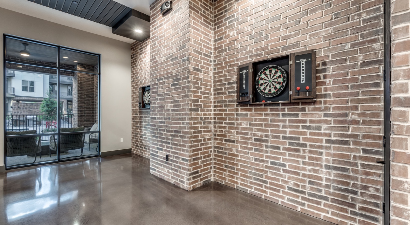 a brick wall with a dart board and a clock at The Cedar at  Branch